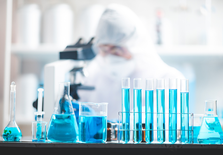 Scientist with beakers