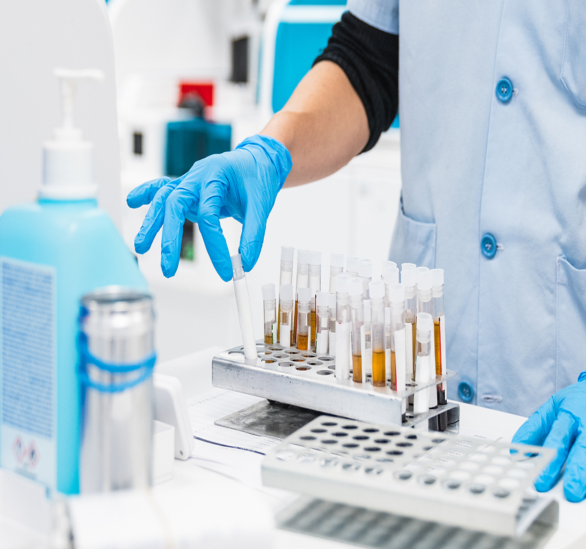 Scientists lifting test tube out of test tube rack